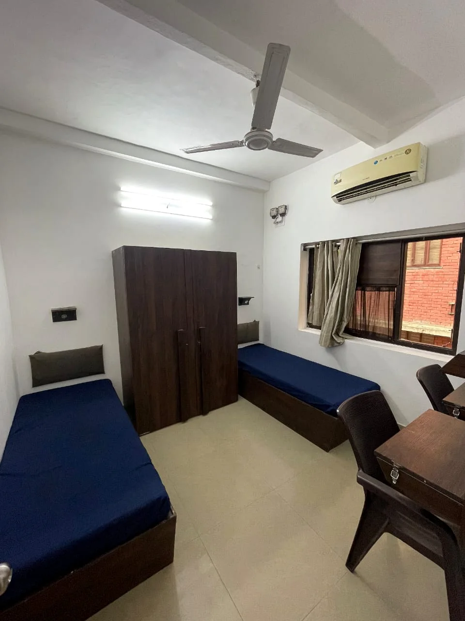 Safe House room with split AC and two beds