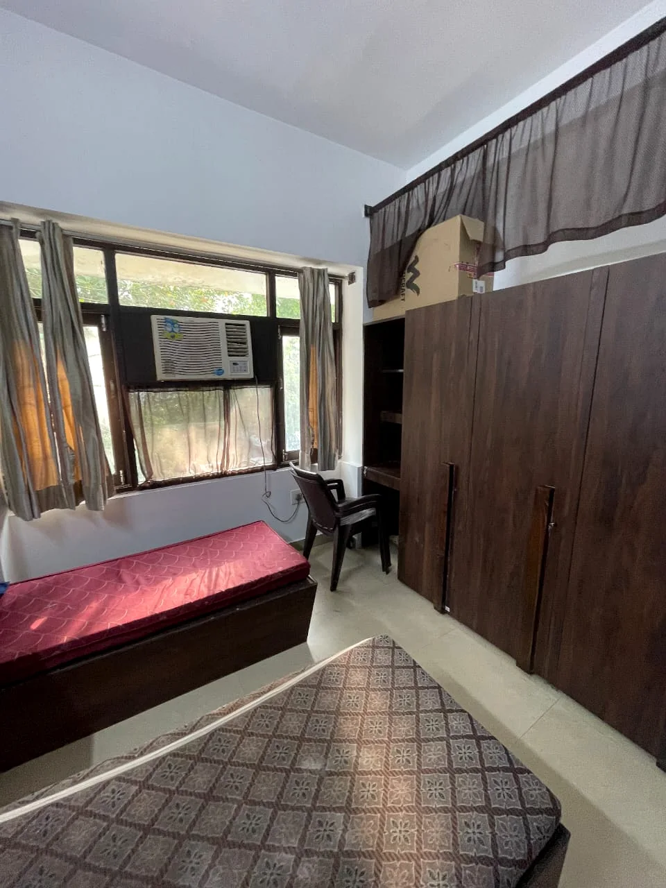 Safe House room with large window and AC
